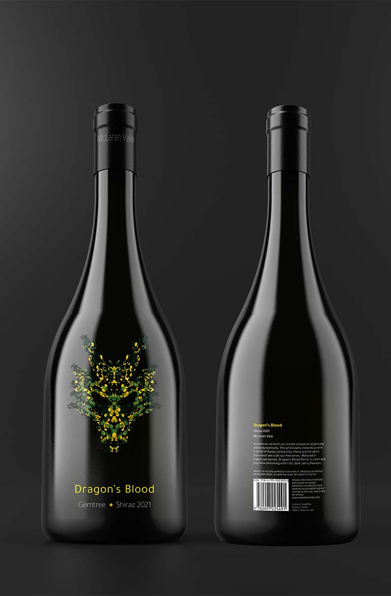 Wine bottle with a green dragon face on it.