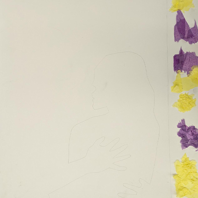 An outline of the couple kissing on paper. This paper is surrounded by tissue paper.